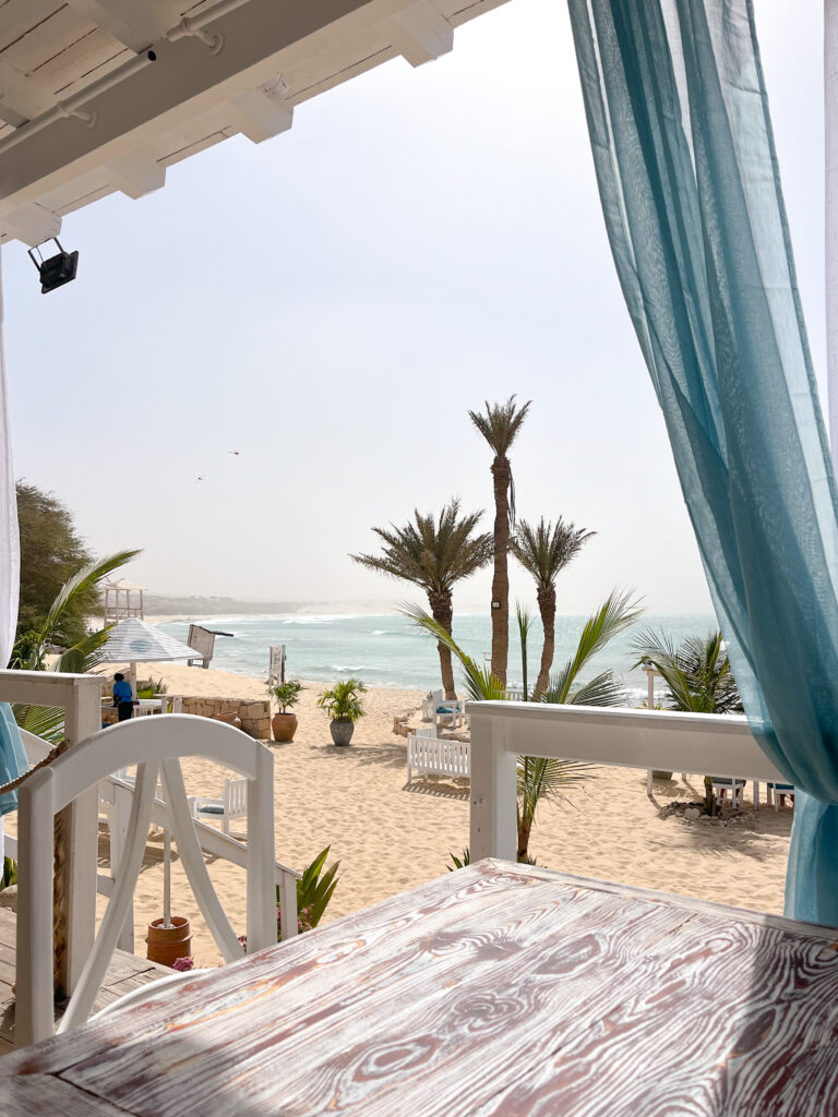 beach restaurant, palmtrees and sand on the most beatiful beach of cabo verde
